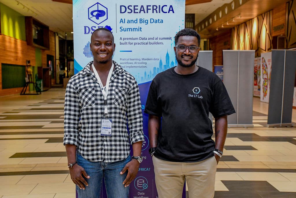 Two attendees at the summit banner between sessions