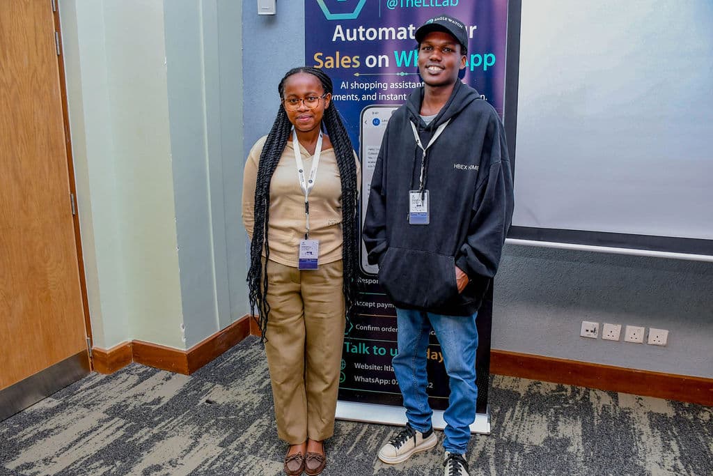 Two attendees at a partner stand during the summit