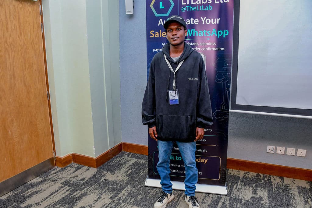 An attendee standing by a partner stand