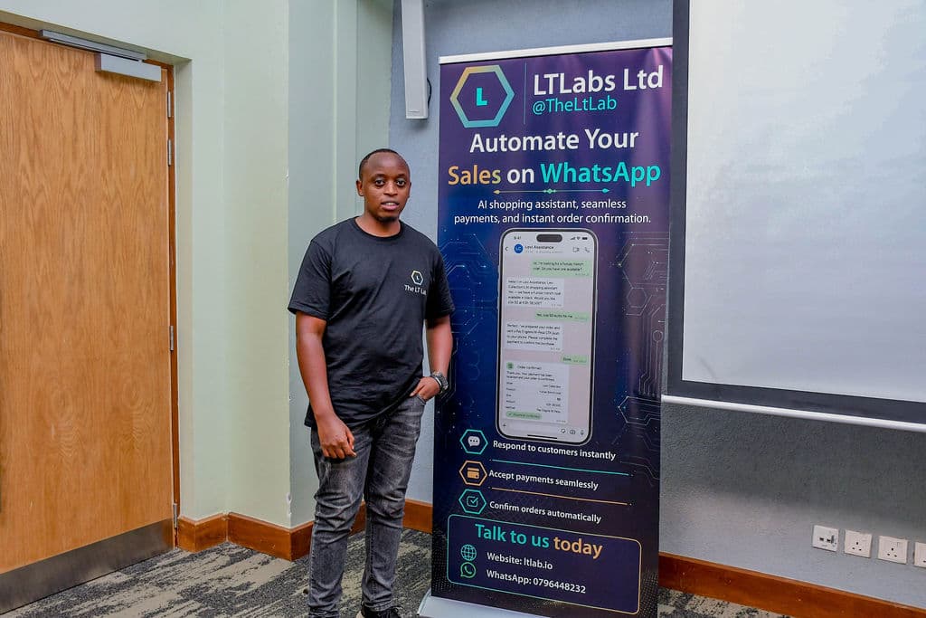 An attendee beside a partner stand at the summit