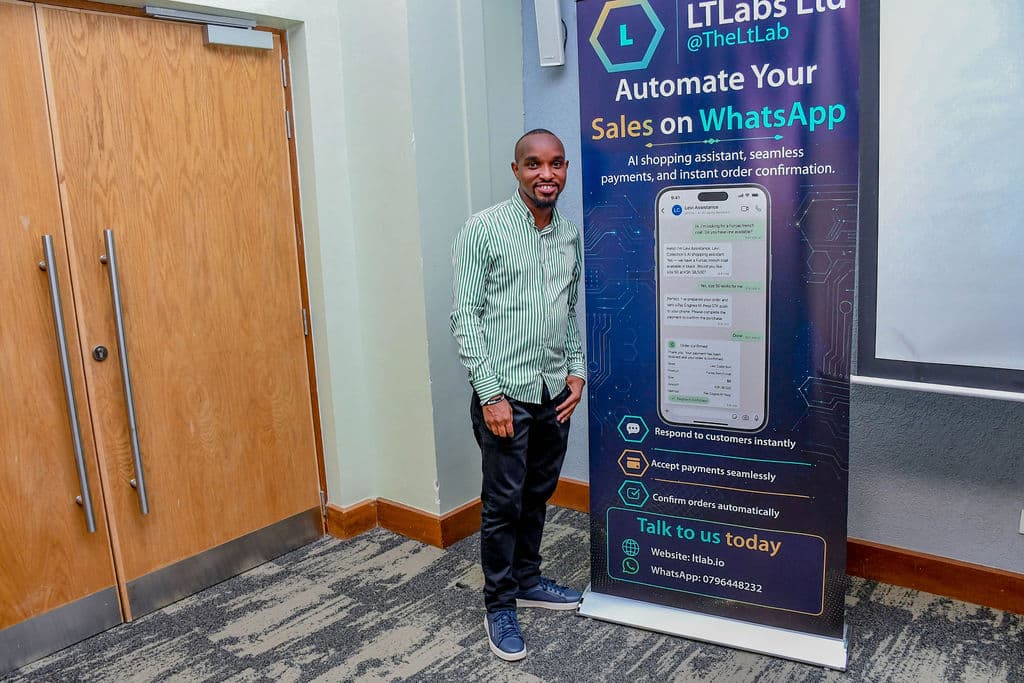 An attendee standing beside a partner stand