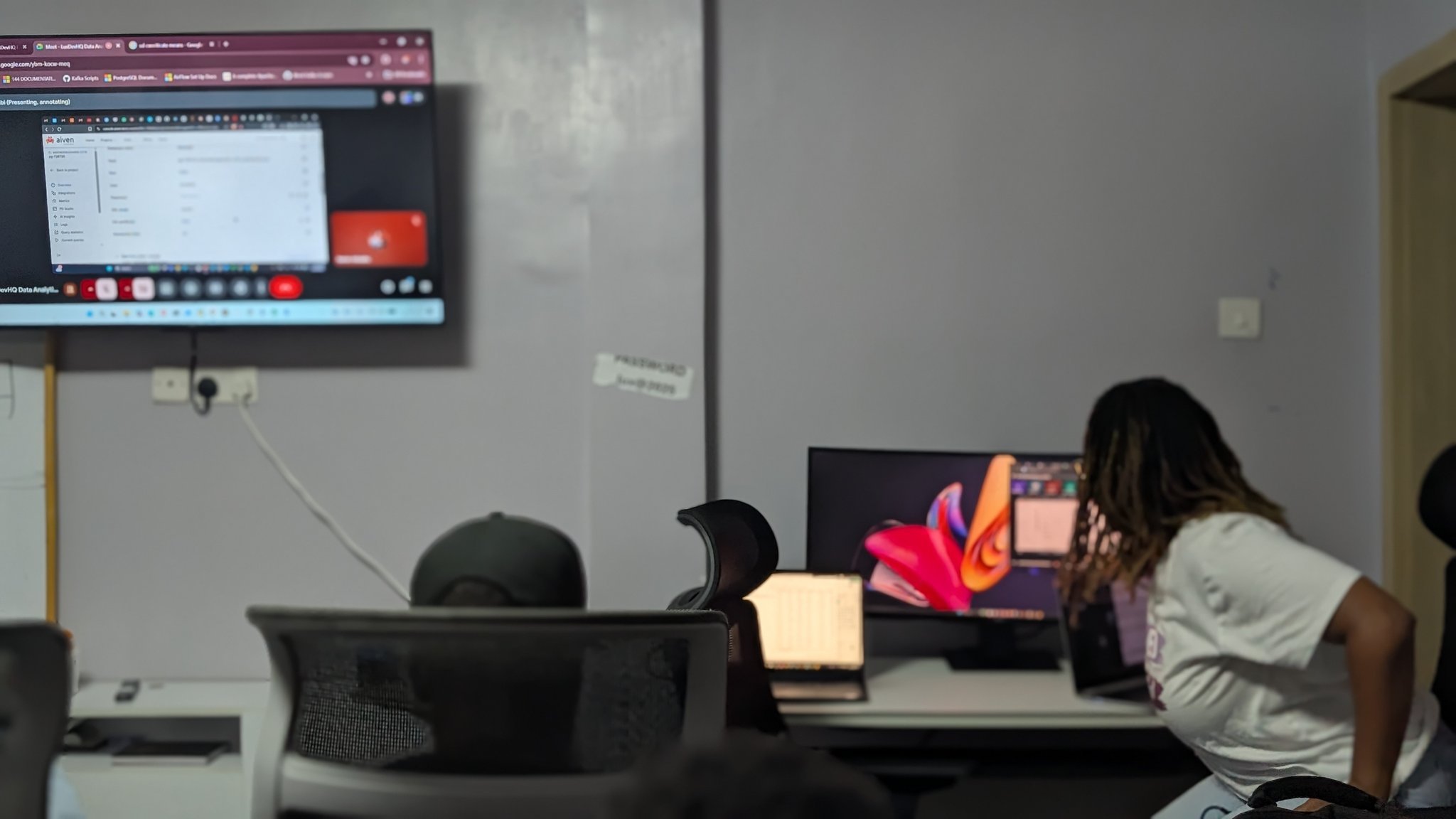 Attendees working together on laptops during a technical workshop.